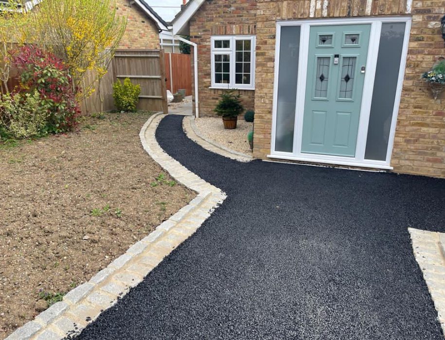 Tarmac driveway with sett edging and a sage green composite door