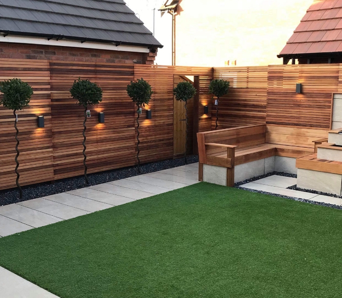 Cedar slat screen, topiary, porcelain paving and lighting