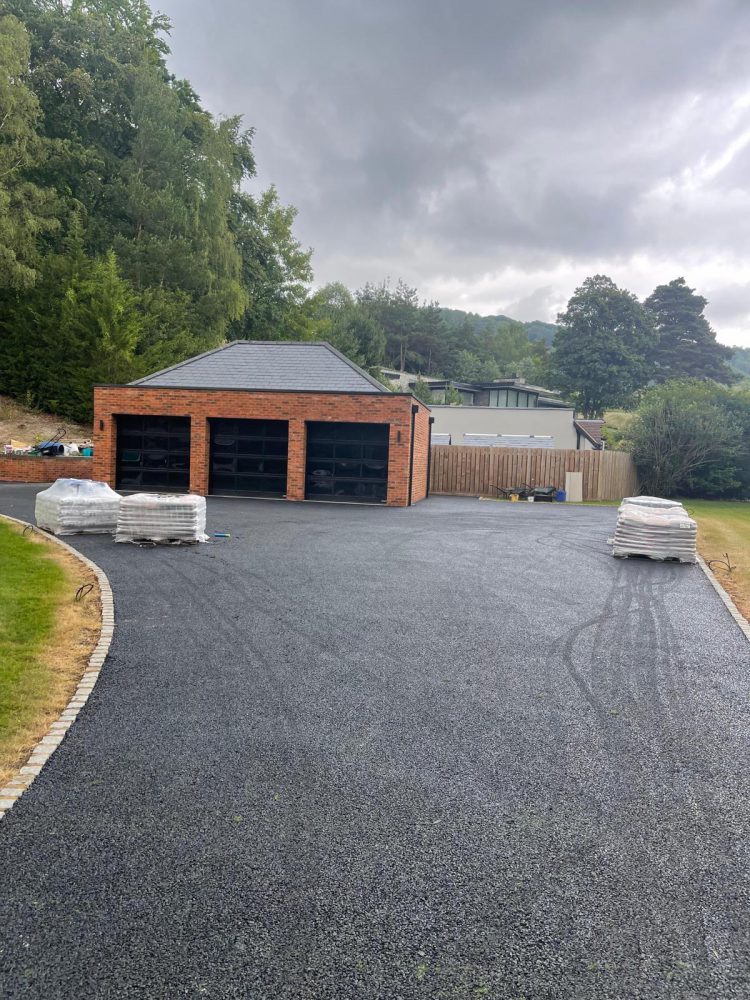 Tarmac driveway to a triple garage in a Wiltshire valley